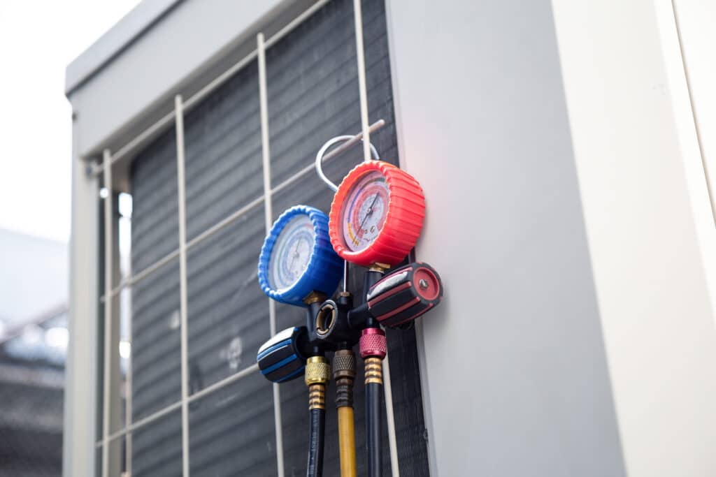 Air conditioning service and HVAC maintenance include using a gauge to check the refrigerant levels in the system.