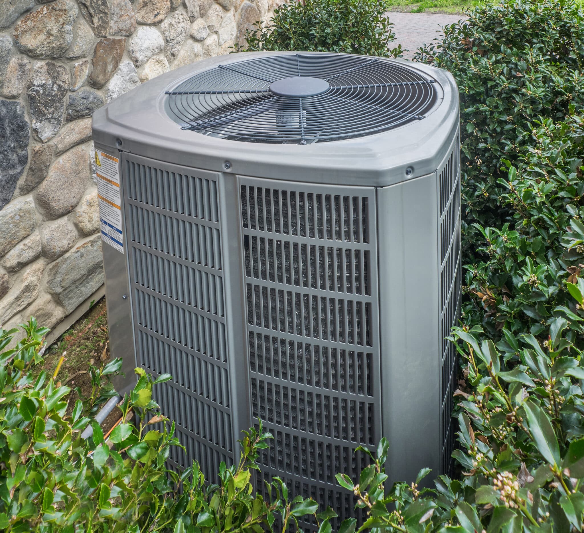 Emergency heating and air conditioning unit located at the back of a residence.