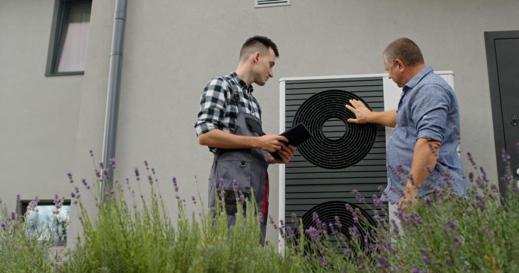 A technician and homeowner discuss heat pump maintenance, HVAC Tips.