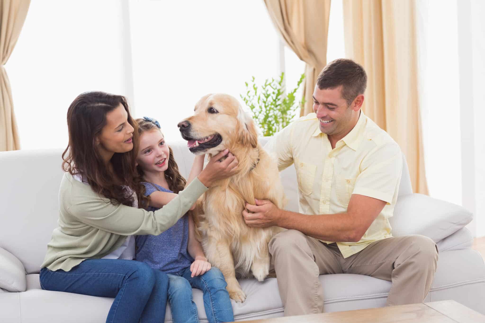 Loving family and dog while sitting on sofa, HVAC Filters.